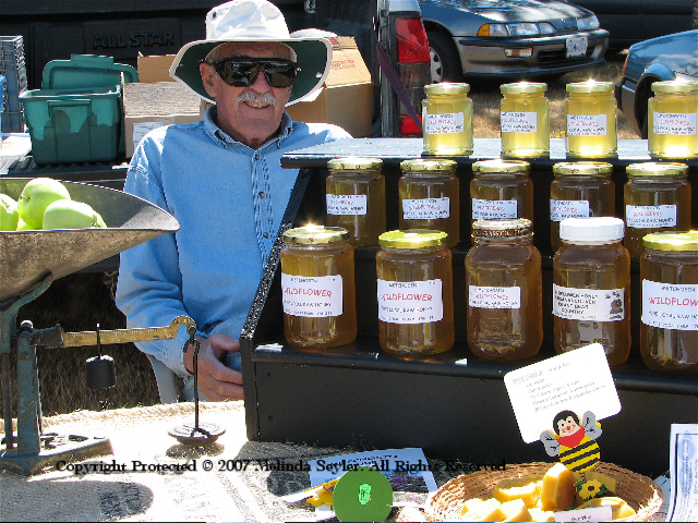 Gentleman selling honey and produce.
